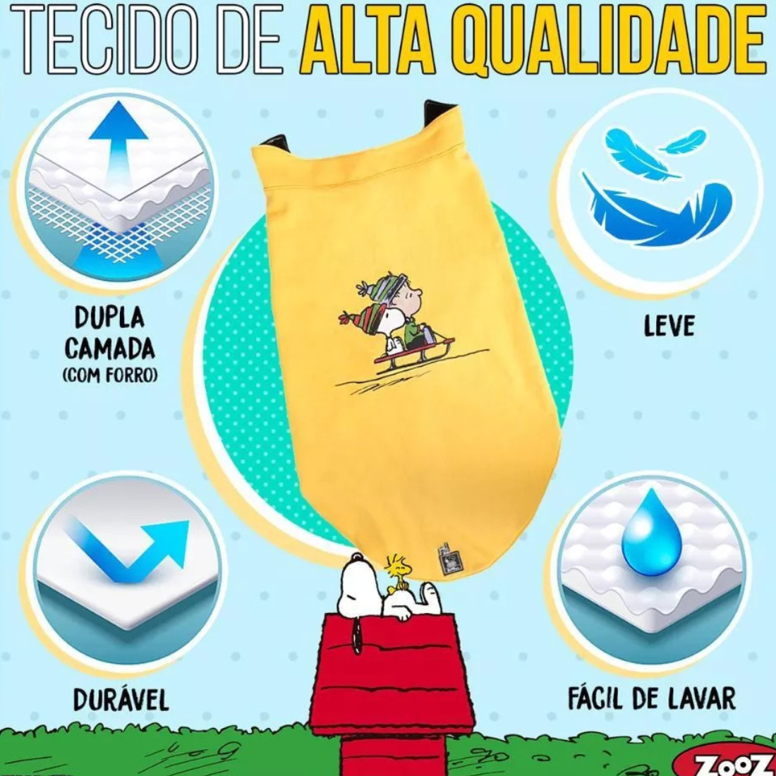 Informação sobre o tecido de um colete  Zooz para cão na cor amarela, com detalhes em preto, com estampa do  personagem a deslizar na neve com um gorro e cachecol, acompanhado do Woodstock. Vista frontal, sobre fundo branco. 